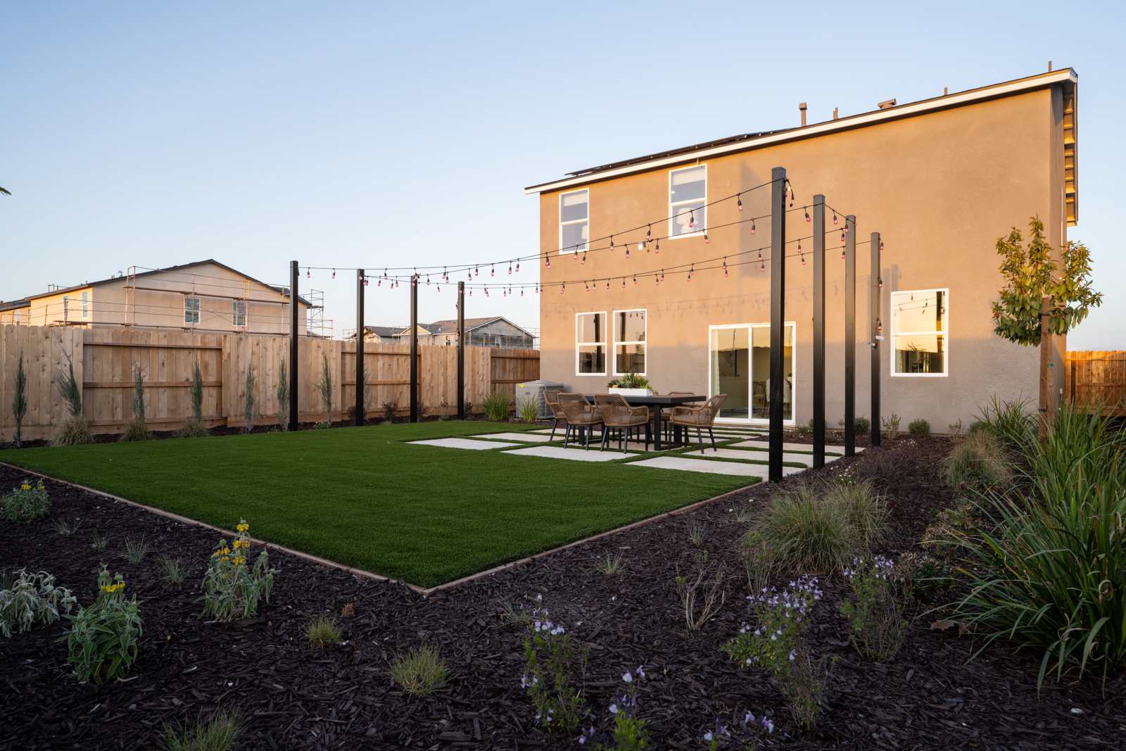 A backyard with a table and chairs.