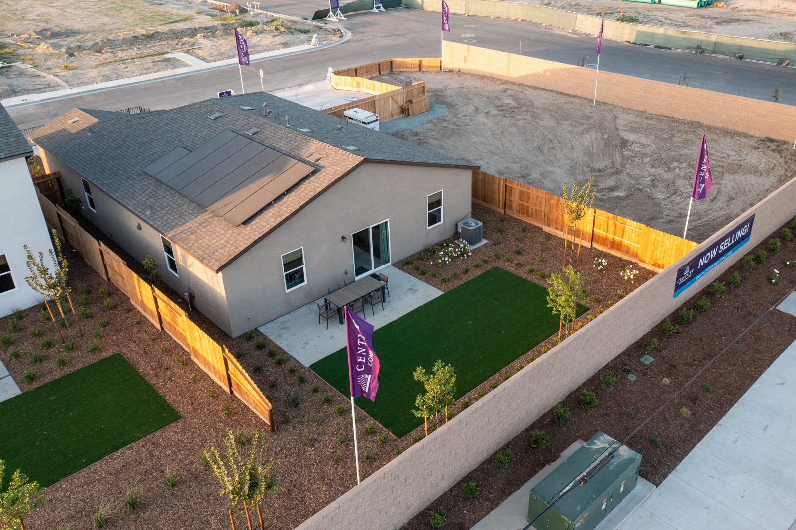 A house with a lawn and a parking lot.