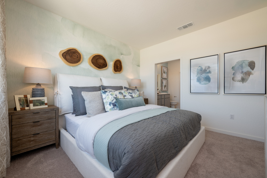 A bedroom with a bed and a dresser.