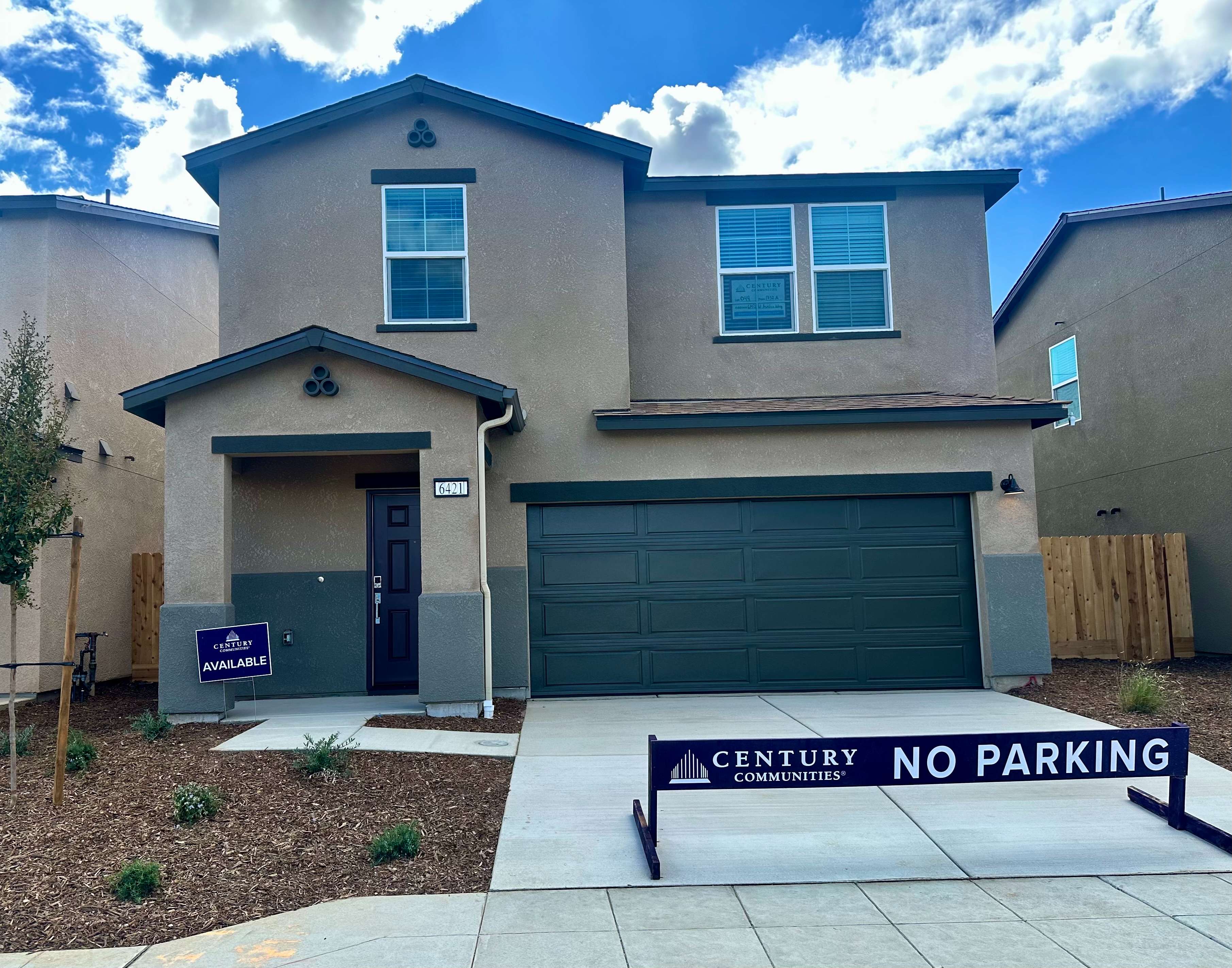 A building with garages and a sign in front of it.