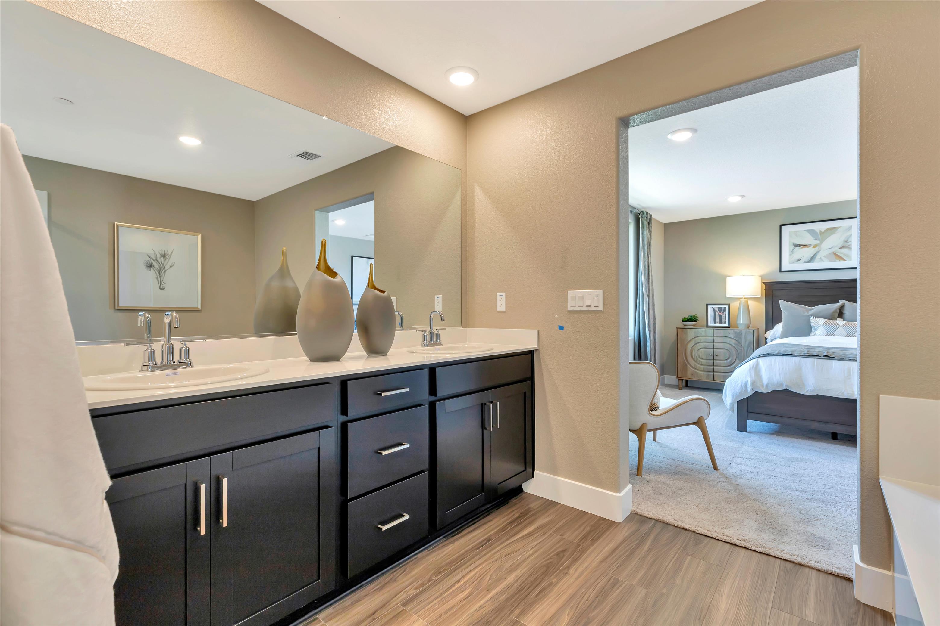 A bathroom with a bed and a mirror.
