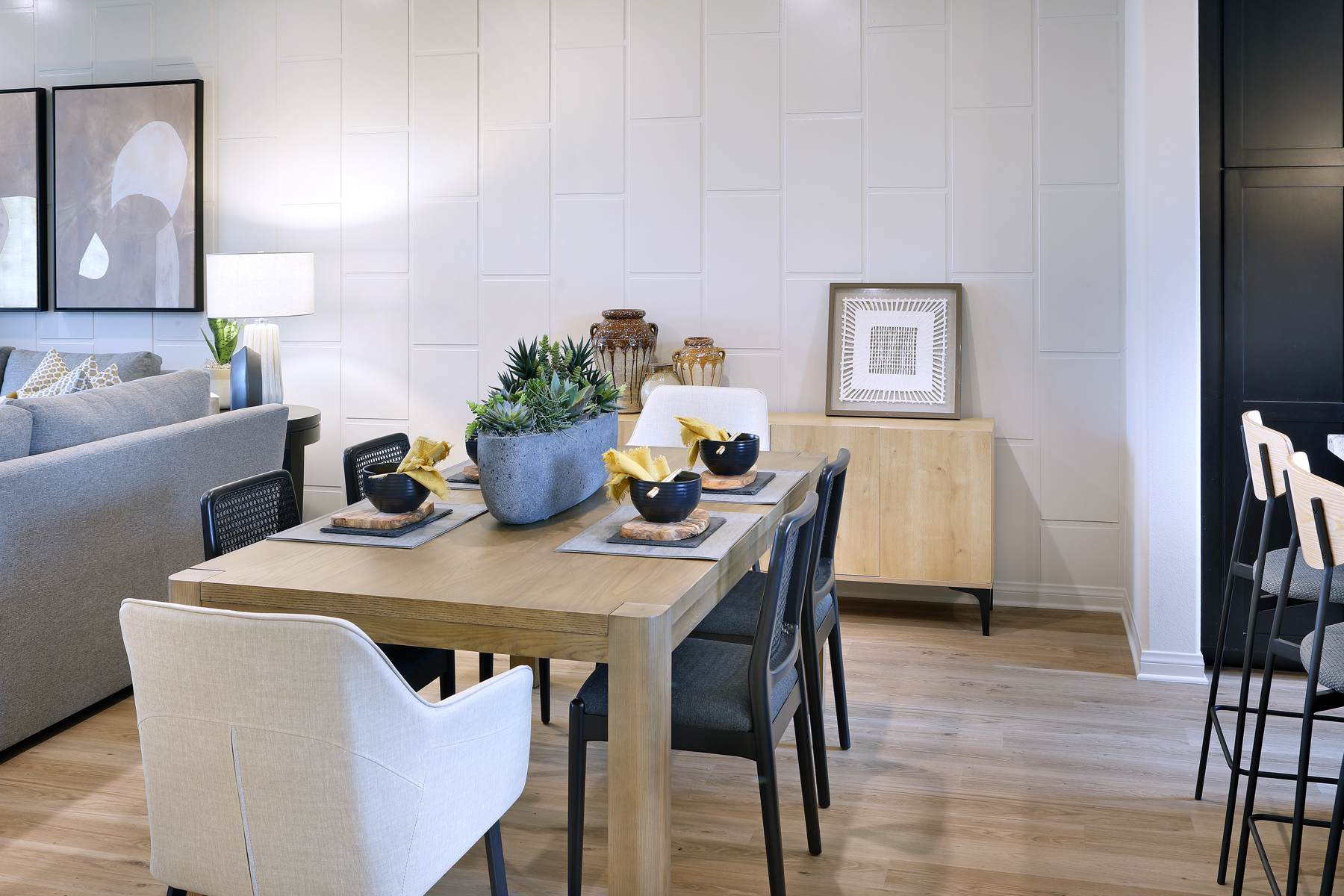A dining room table with chairs and a couch.