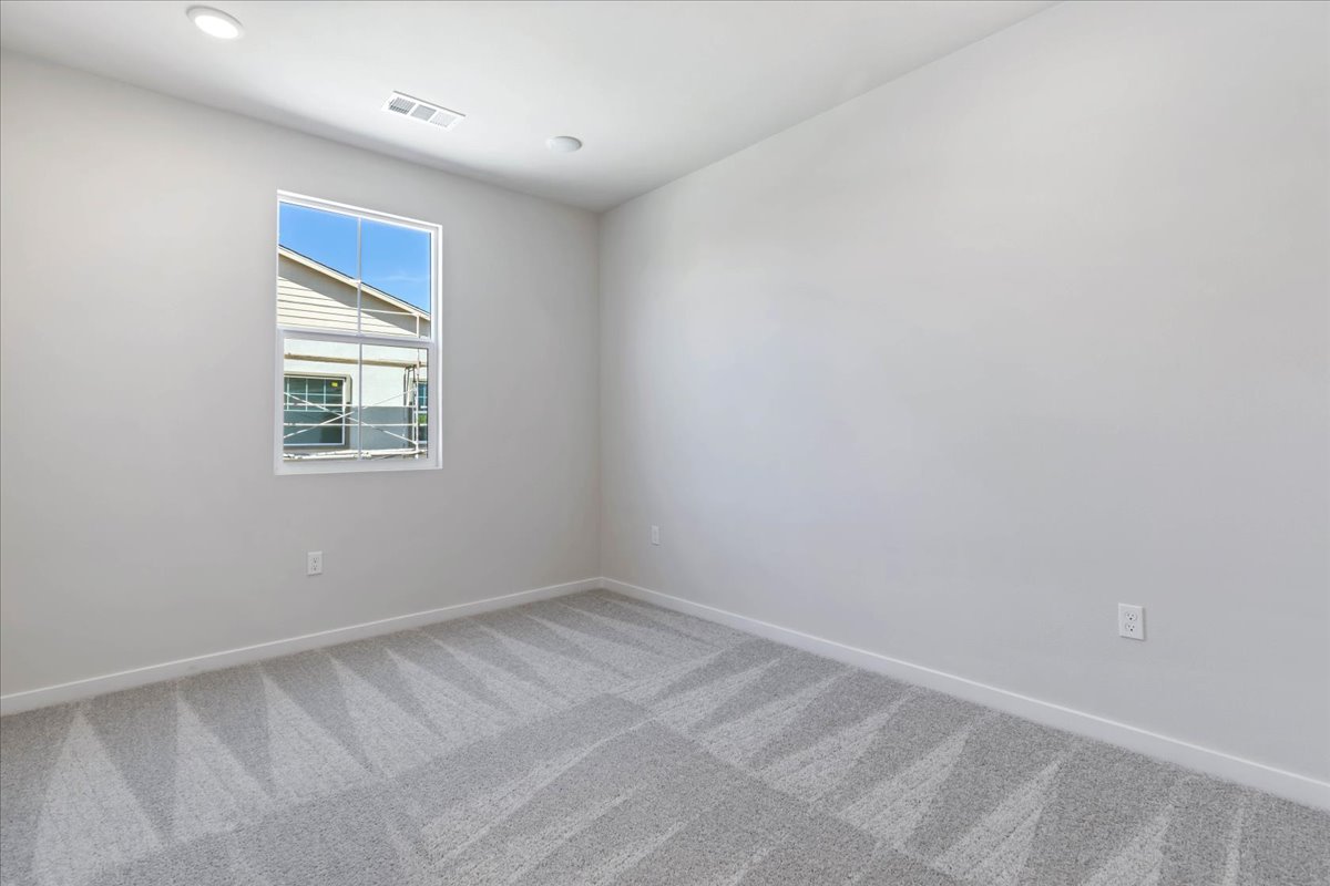 A room with a window and a tile floor.