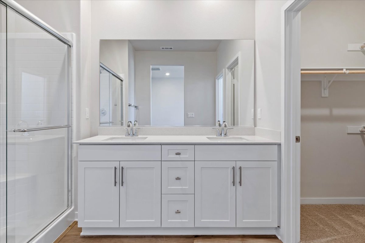 A bathroom with white cabinets.