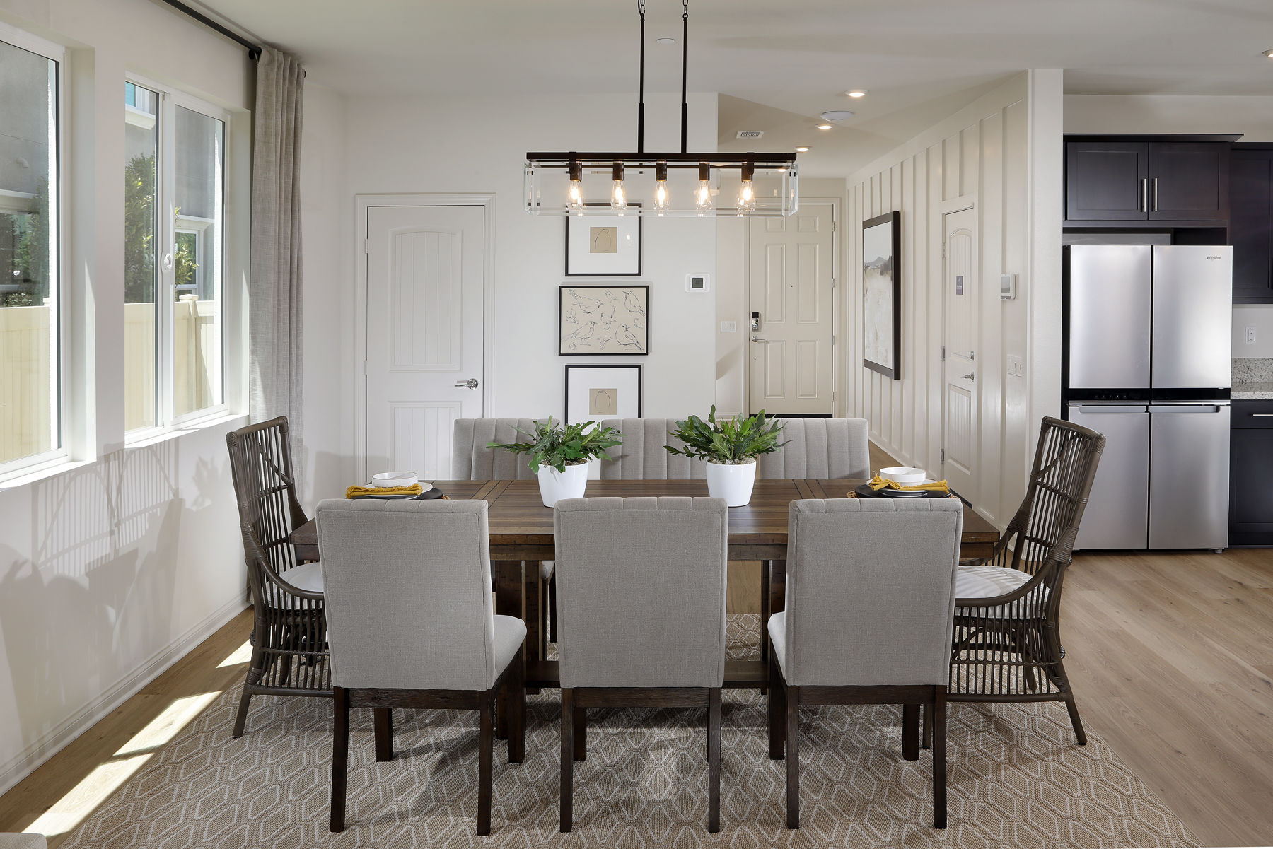 A dining room with a table and chairs.