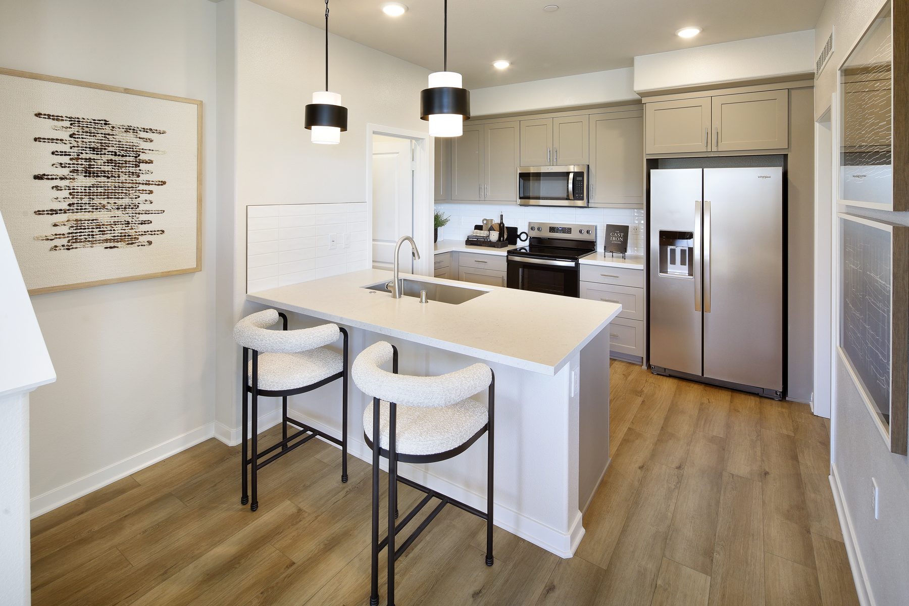 A kitchen with a table and chairs.