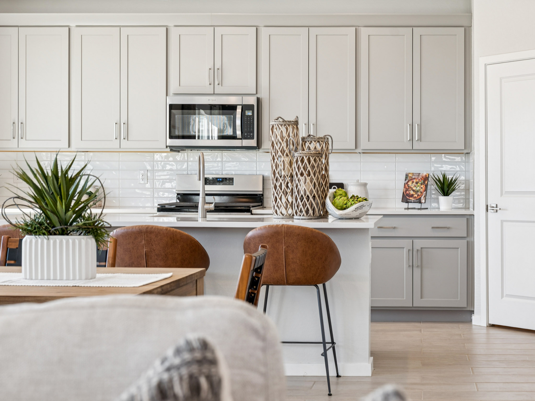 A kitchen with white cabinets.