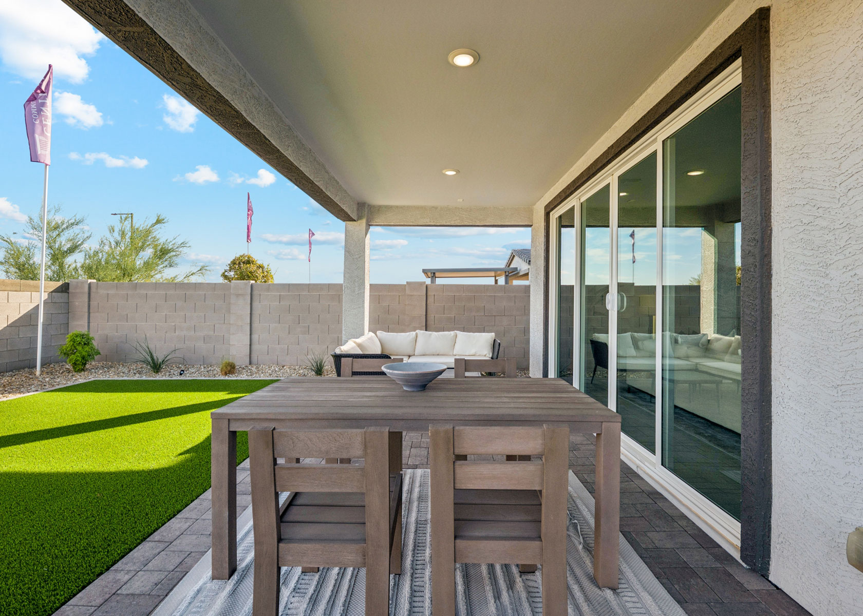 A table and chairs outside a building.