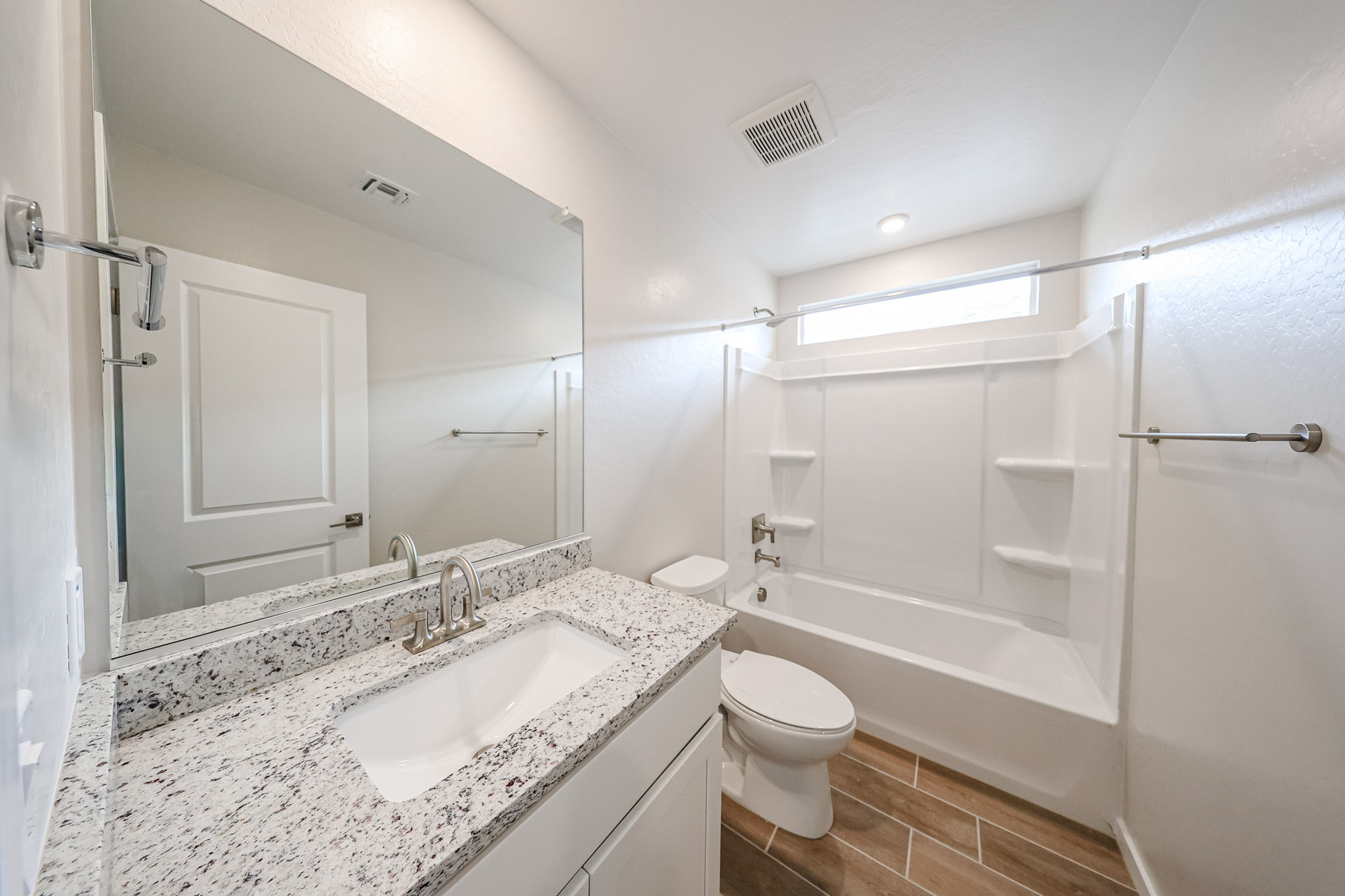 A bathroom with a sink and a shower.