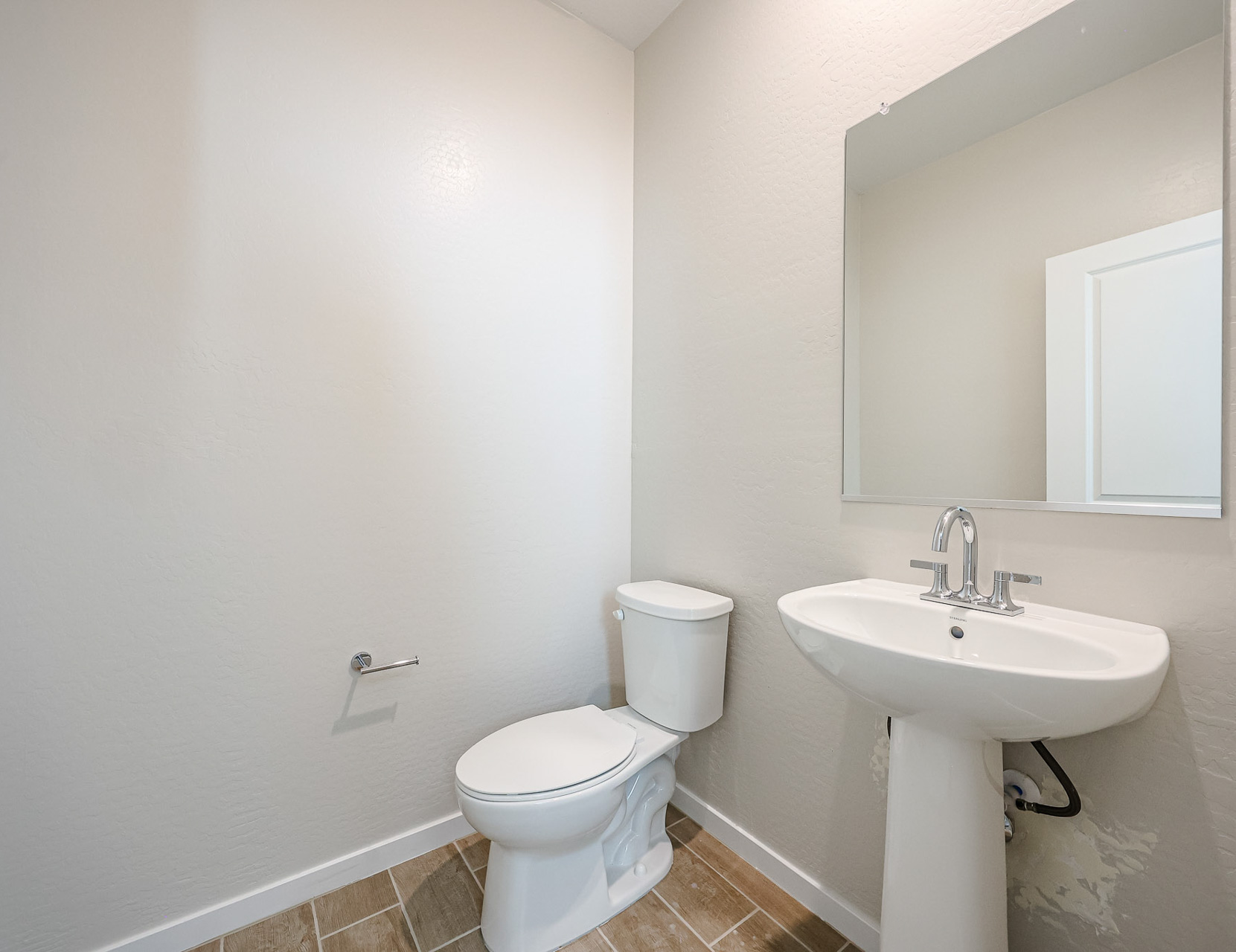 A bathroom with a toilet and sink.