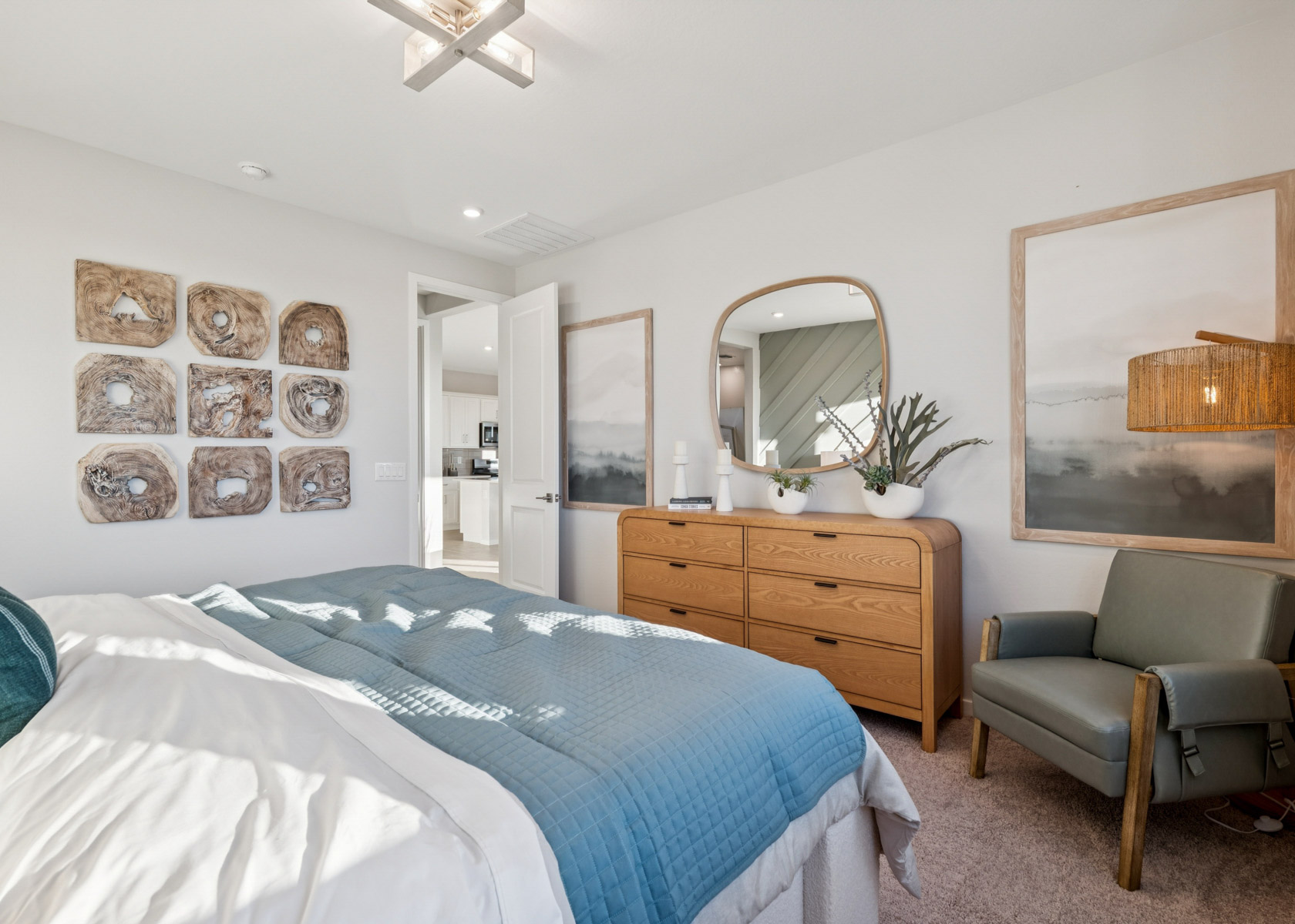 A bedroom with a bed and a chair.