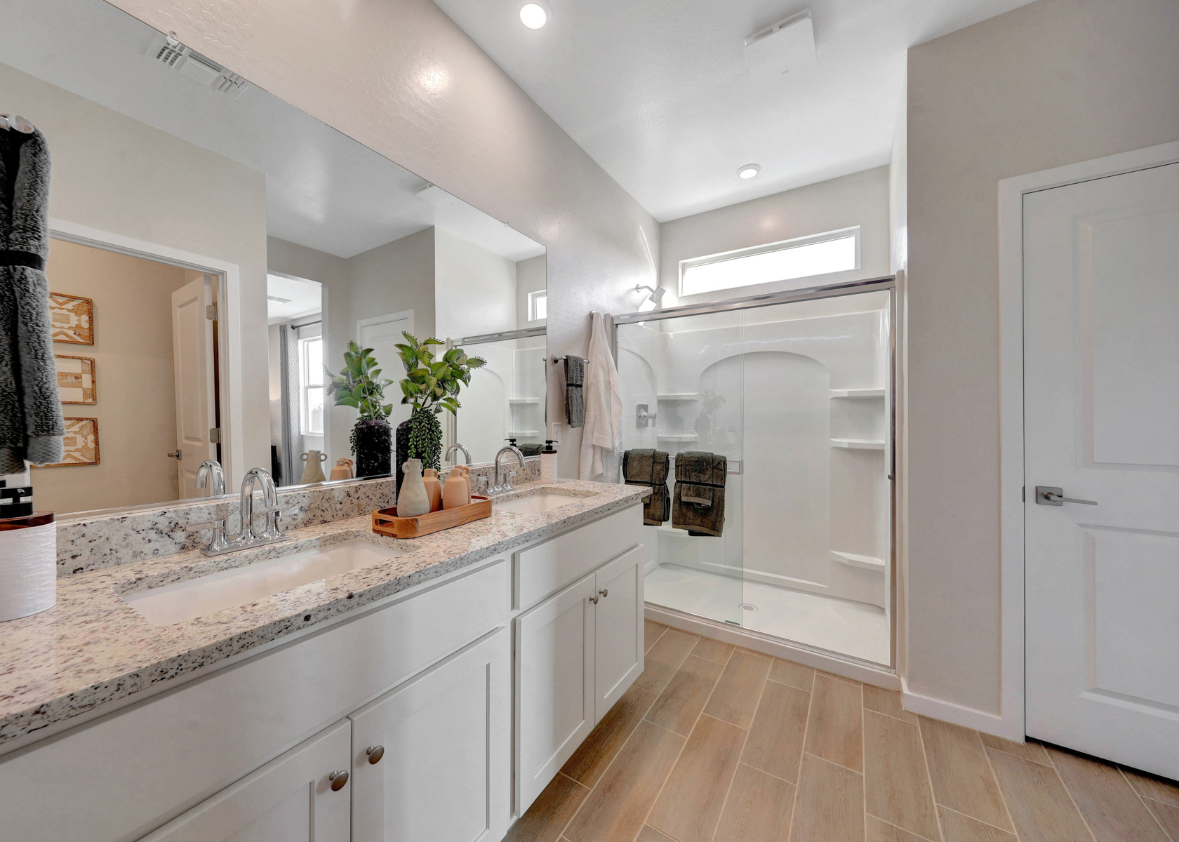 A bathroom with a large mirror.
