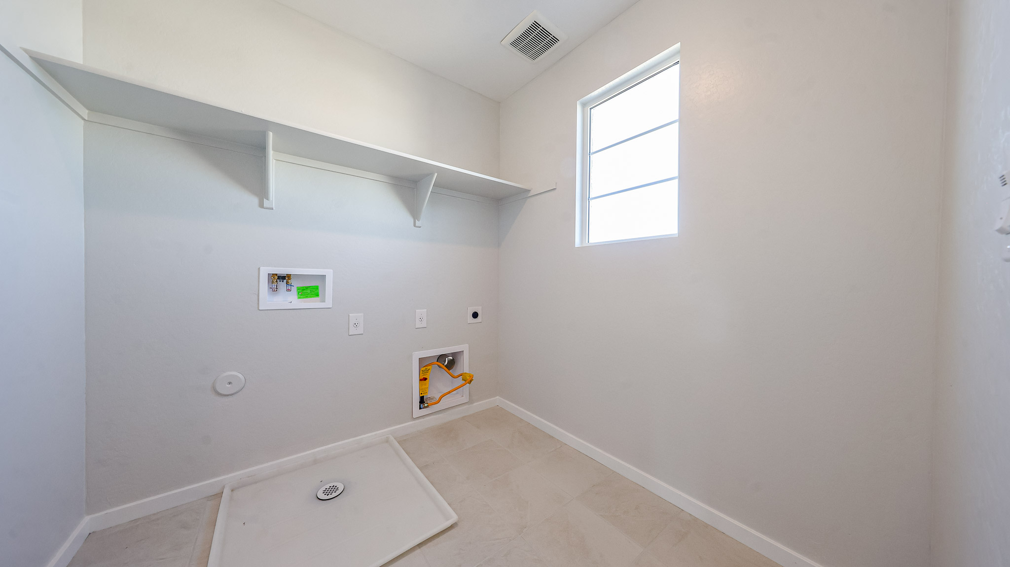 A room with a sink and a window.