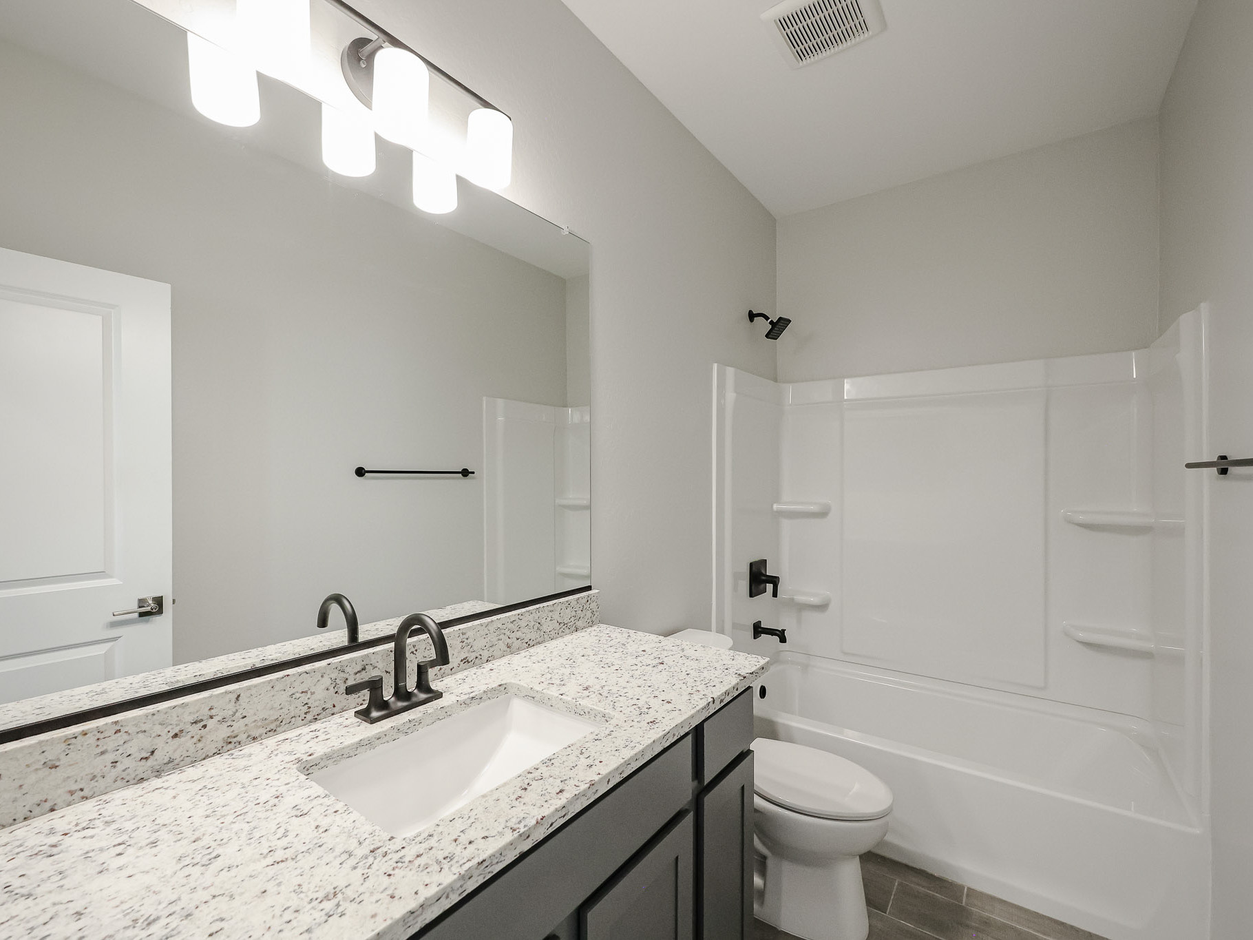 A bathroom with a marble countertop.