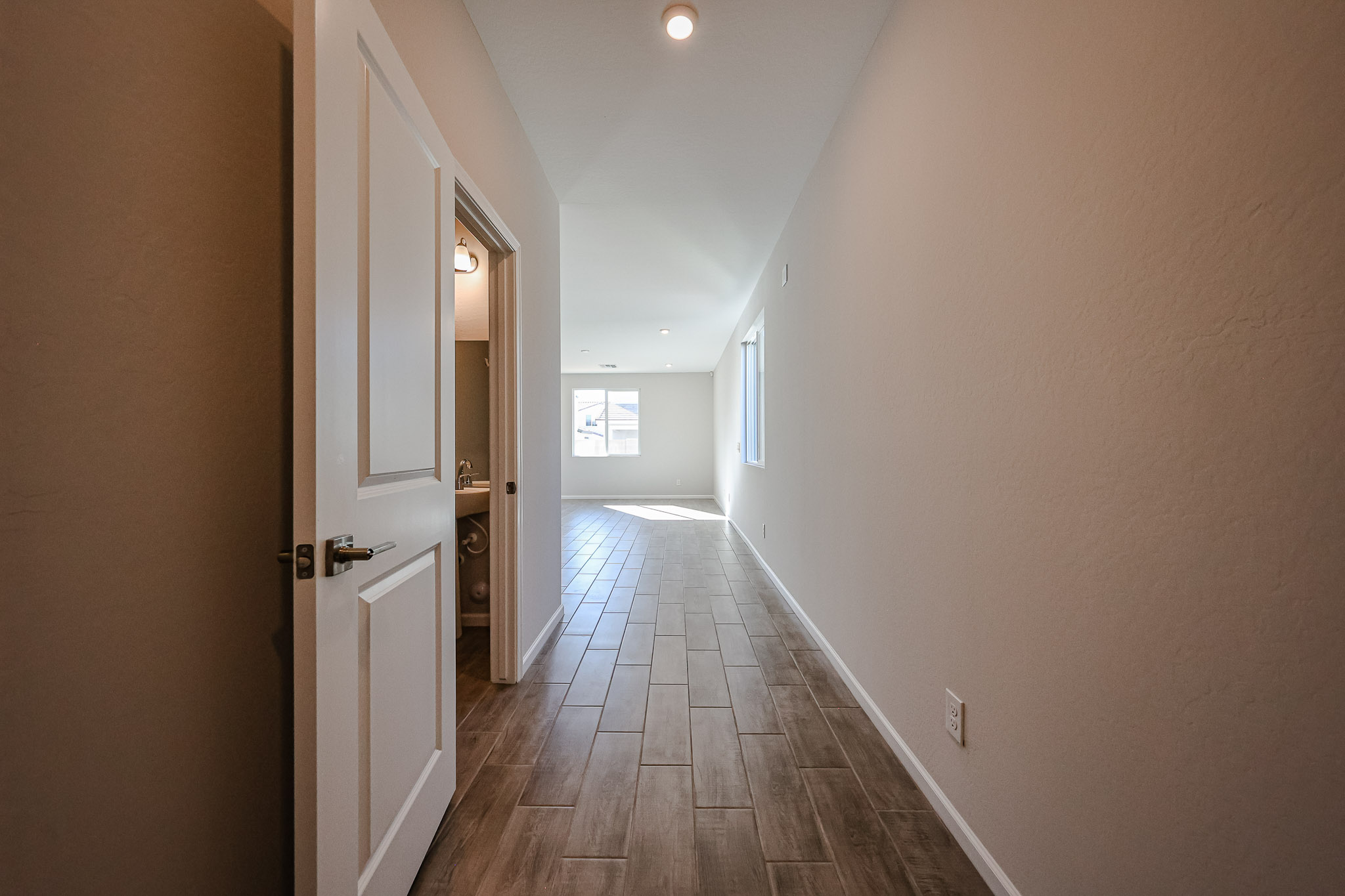 A hallway with doors and windows.