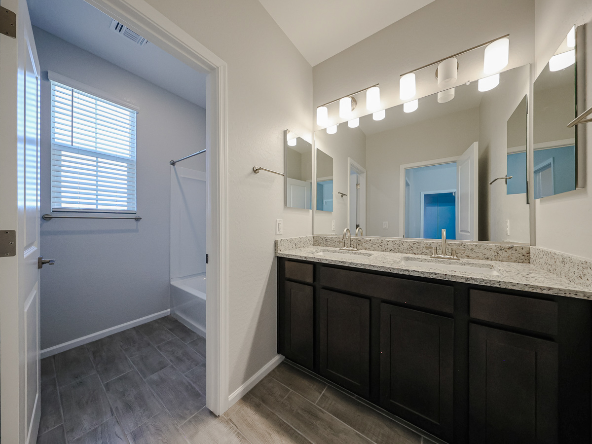 A bathroom with a marble countertop.