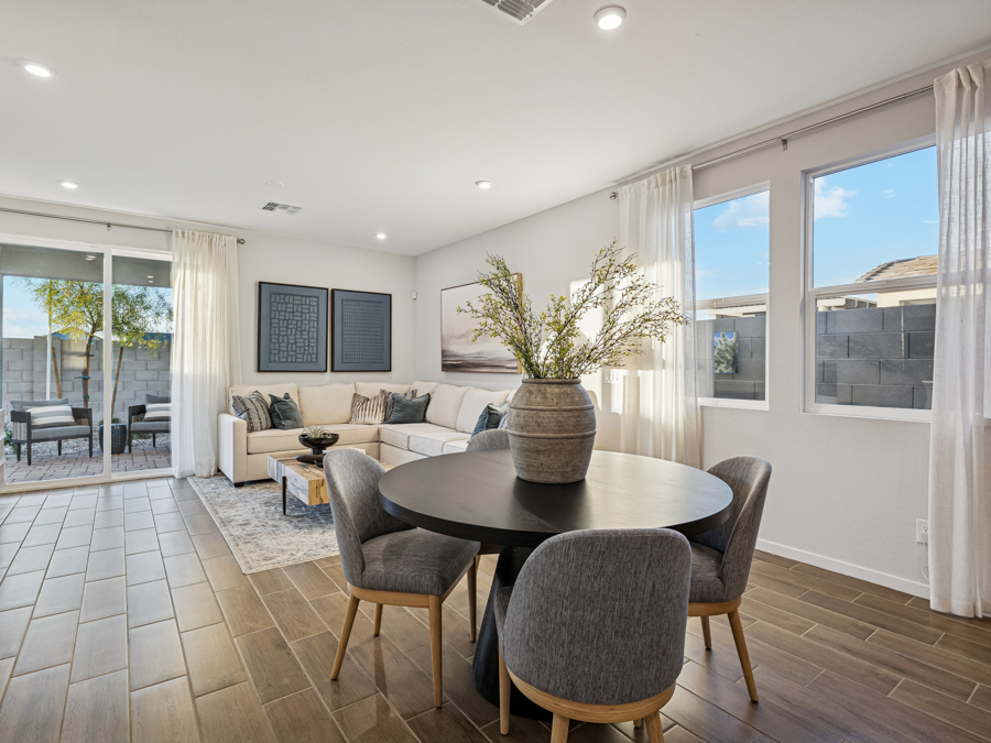 A living room with a table and chairs.