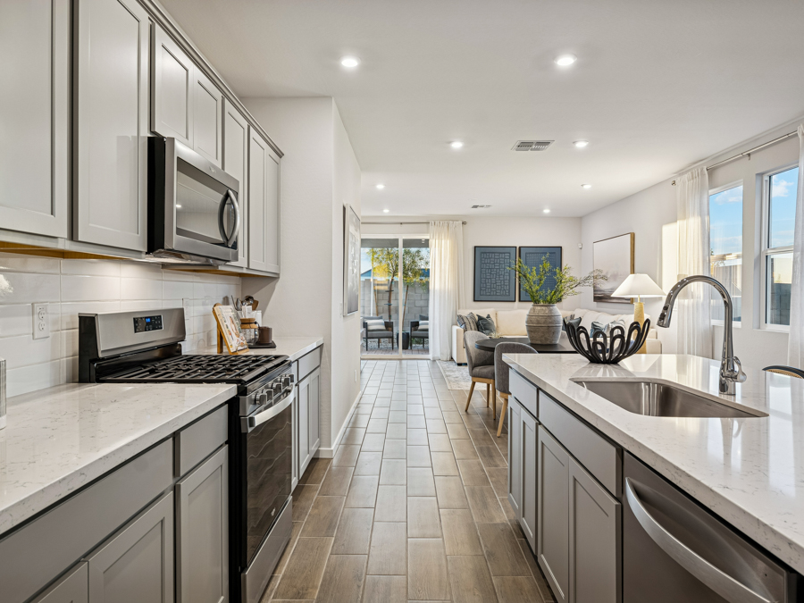 A kitchen with white cabinets.