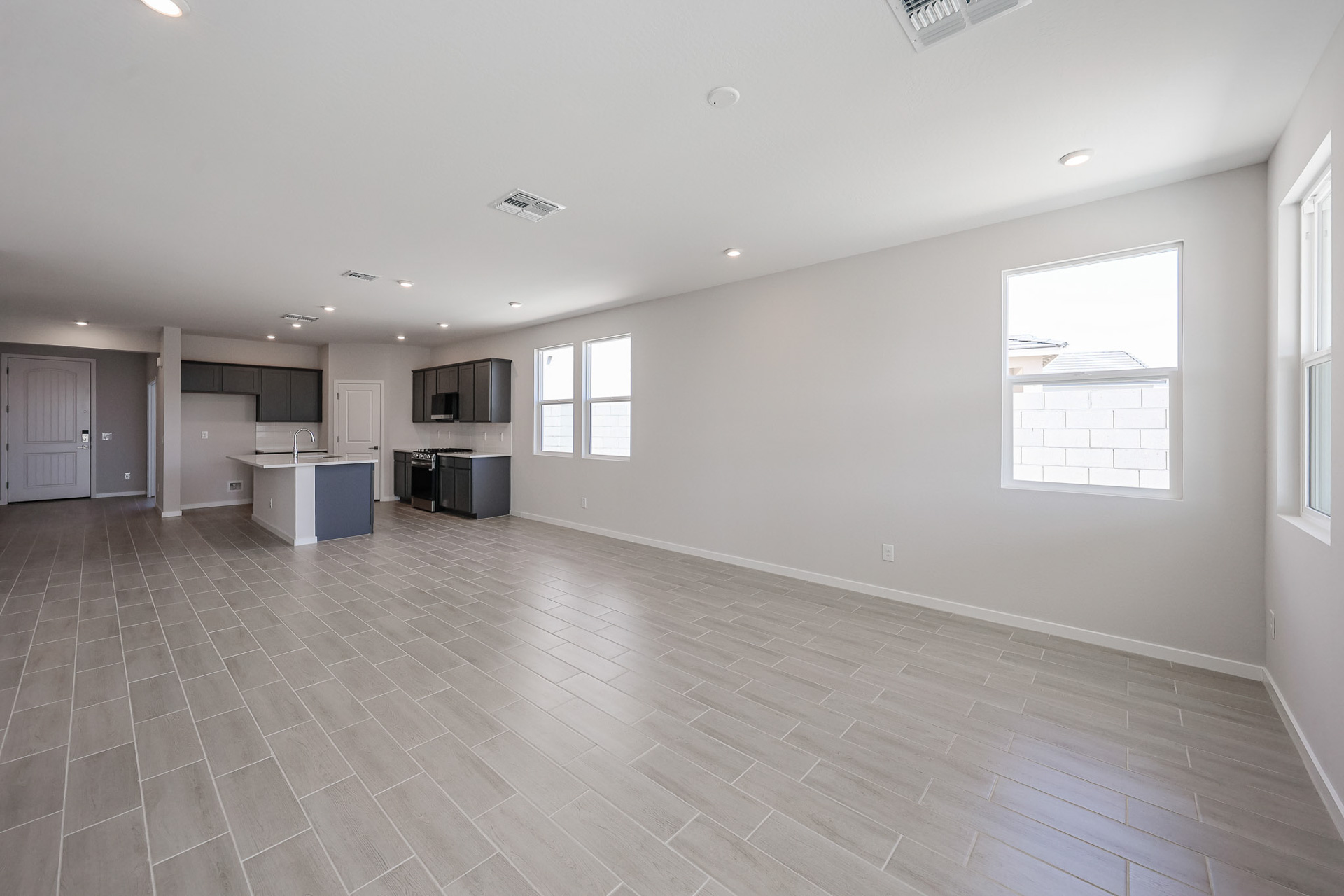 A large empty room with a wood floor and white walls.