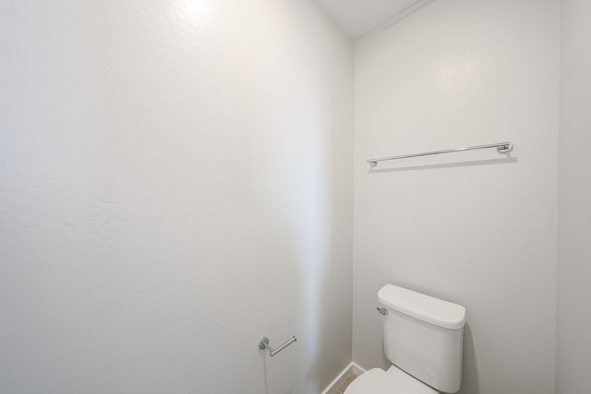 A toilet in a bathroom.