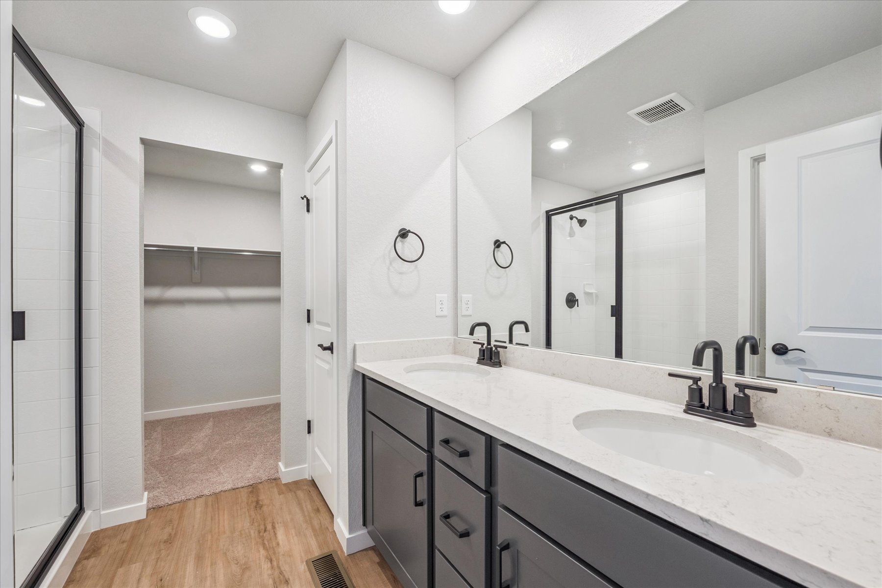 A bathroom with a large mirror.