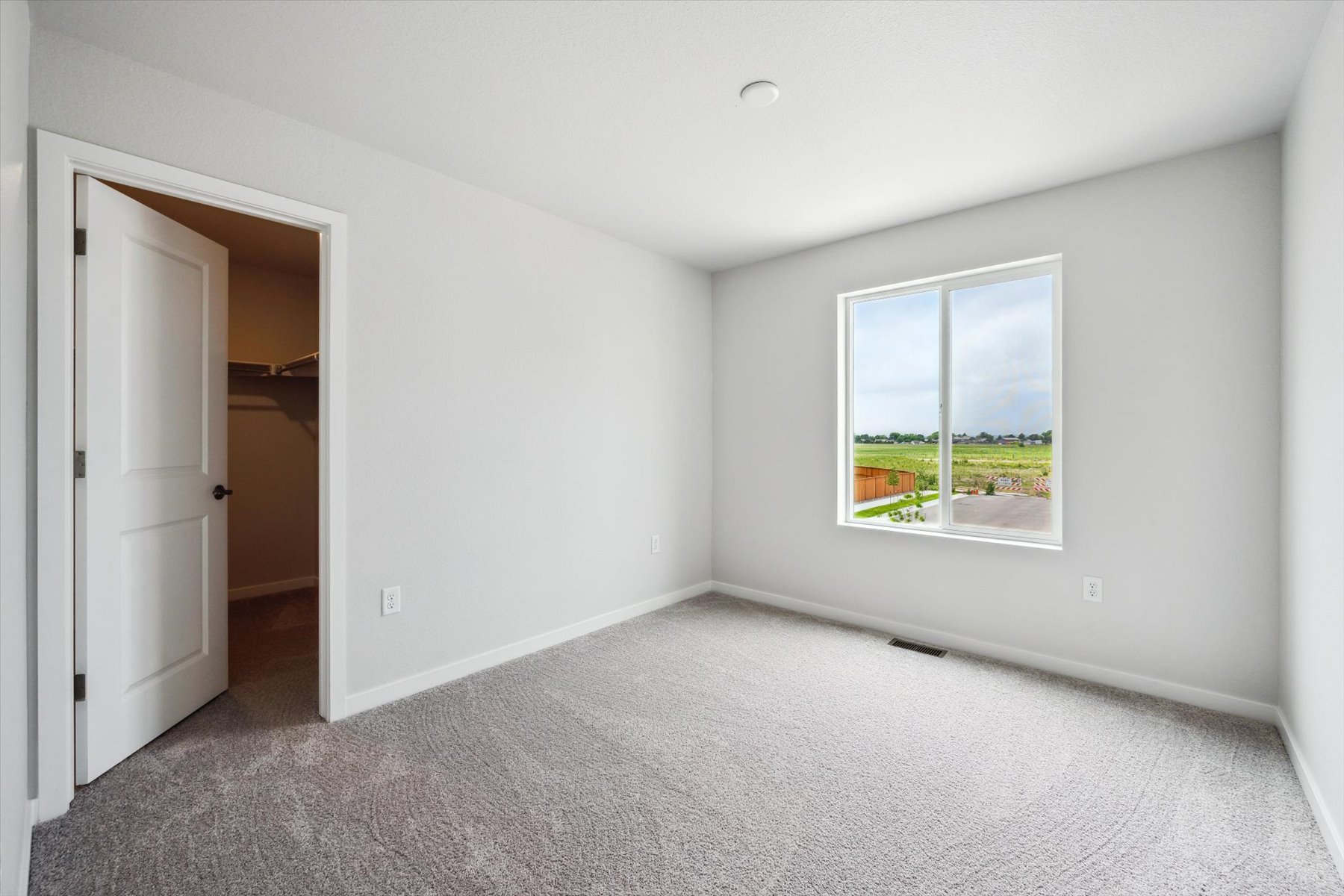 A room with a window and a door.