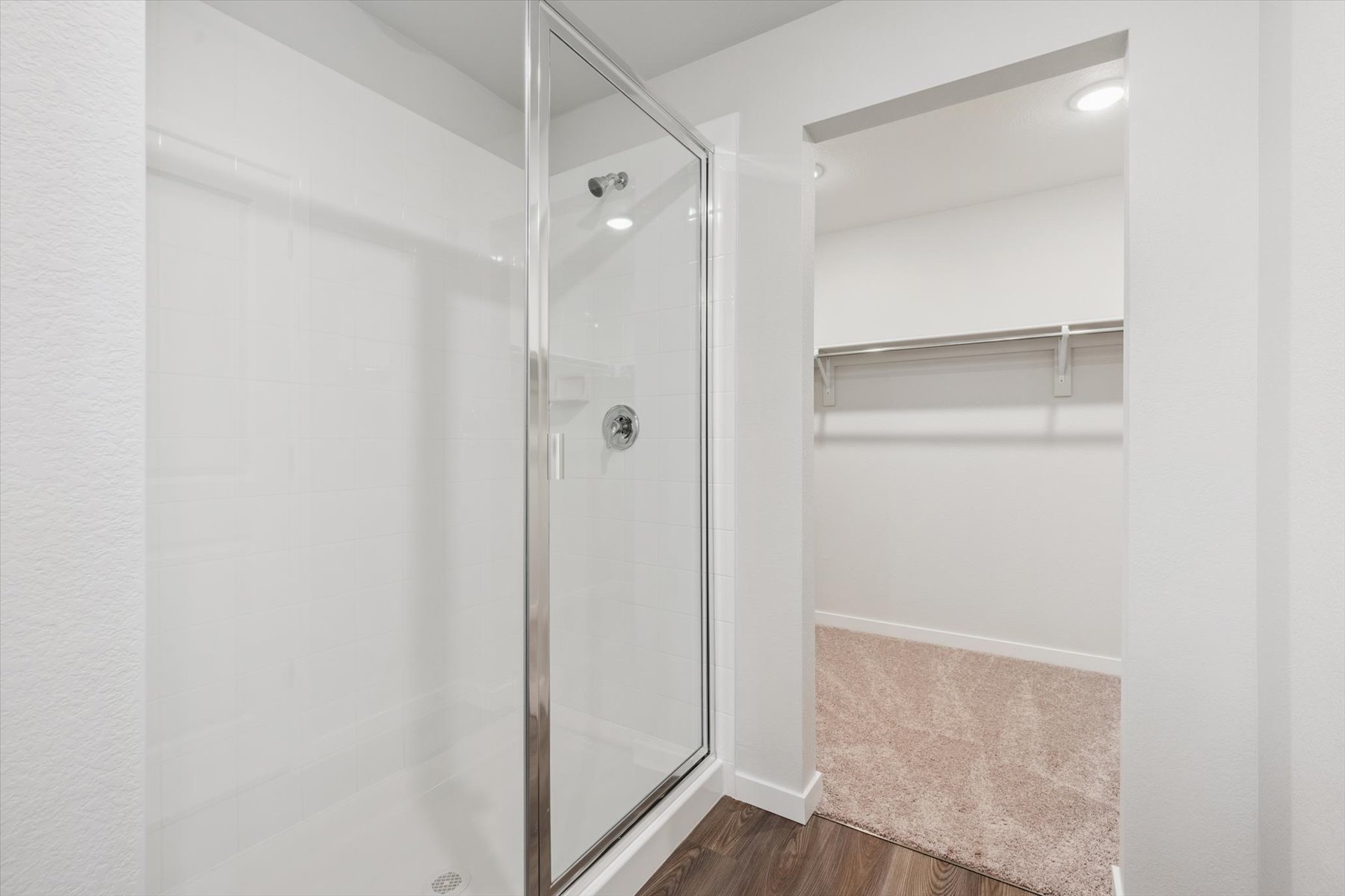 A shower with a glass door.