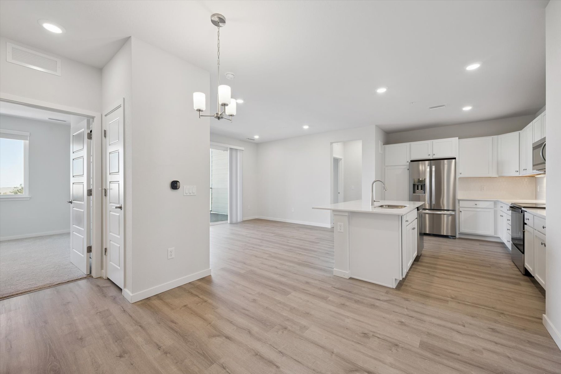 A kitchen with white cabinets.