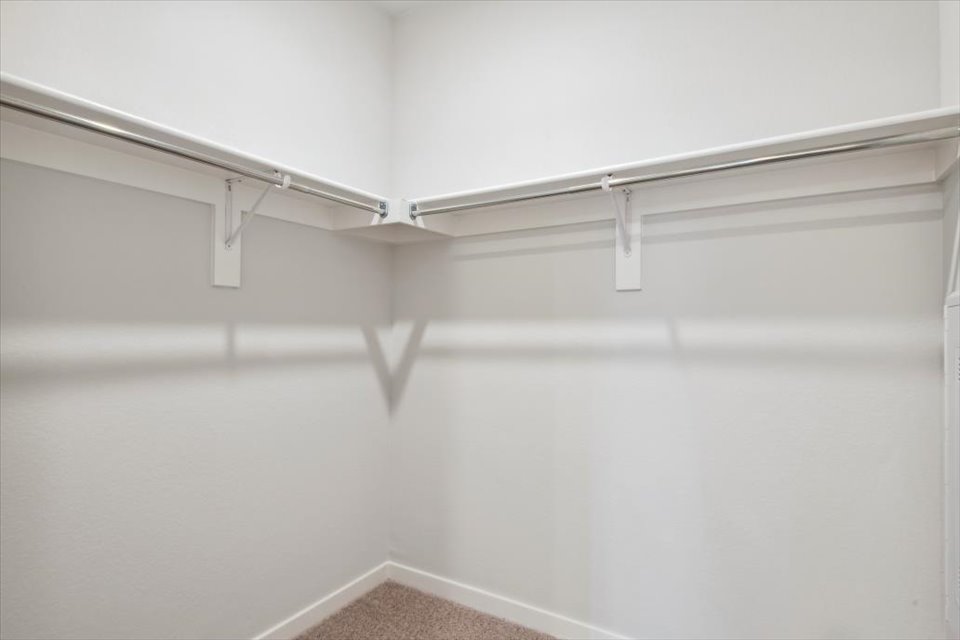 A white wall with a light fixture.