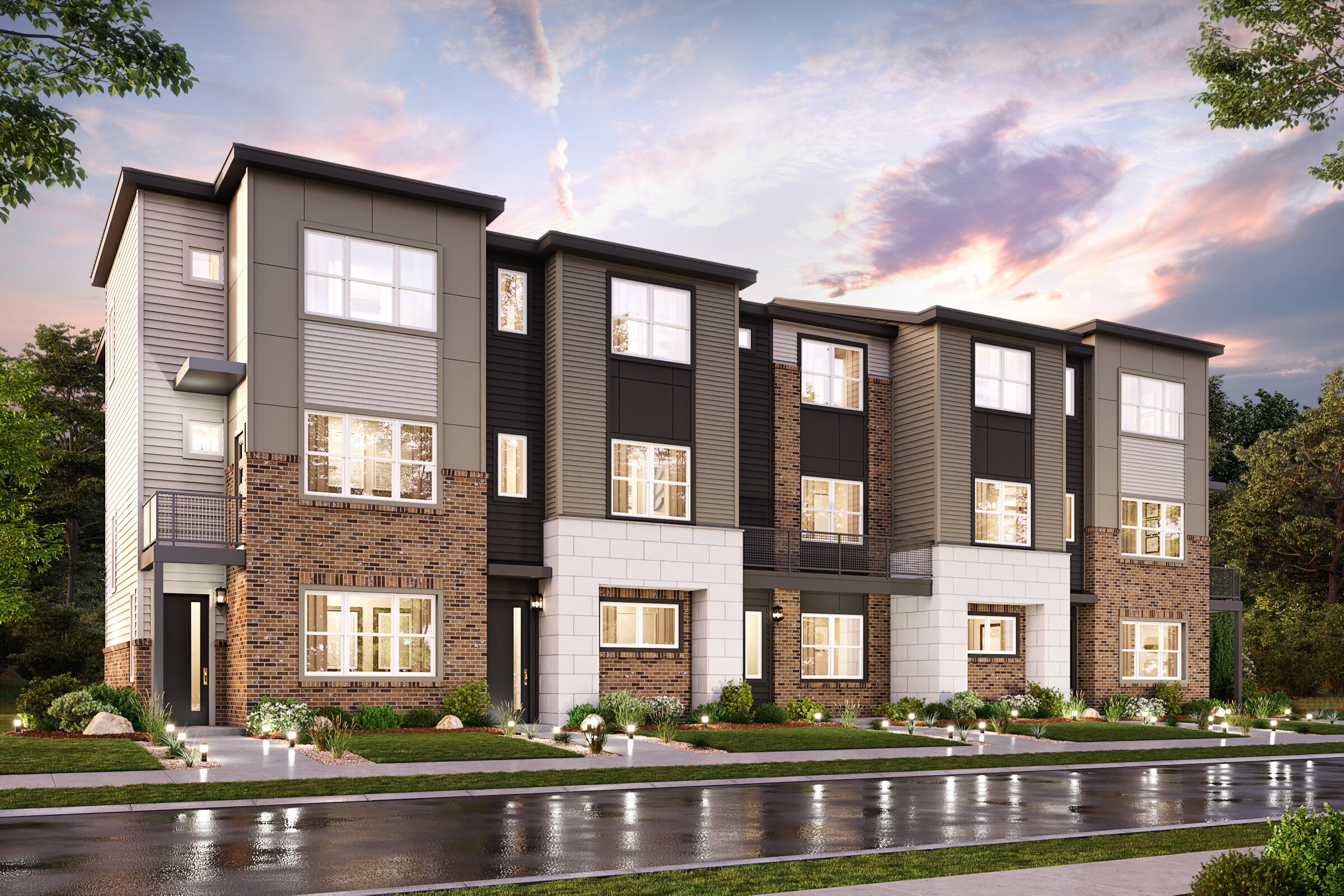 A large brick building with a pond in front of it.