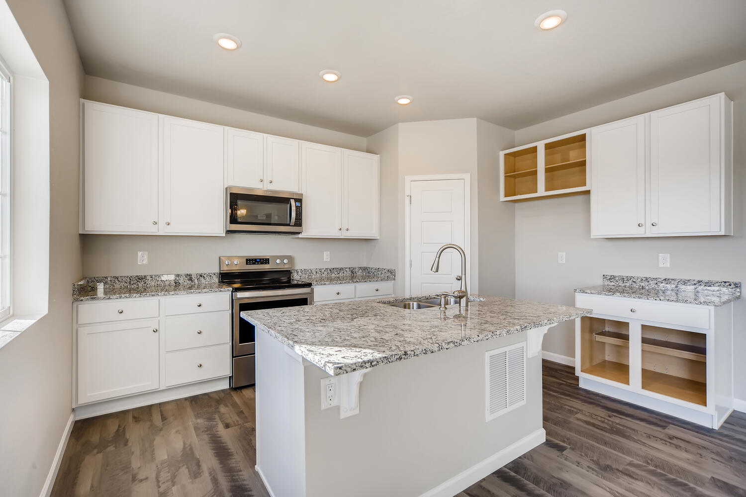 A kitchen with white cabinets.