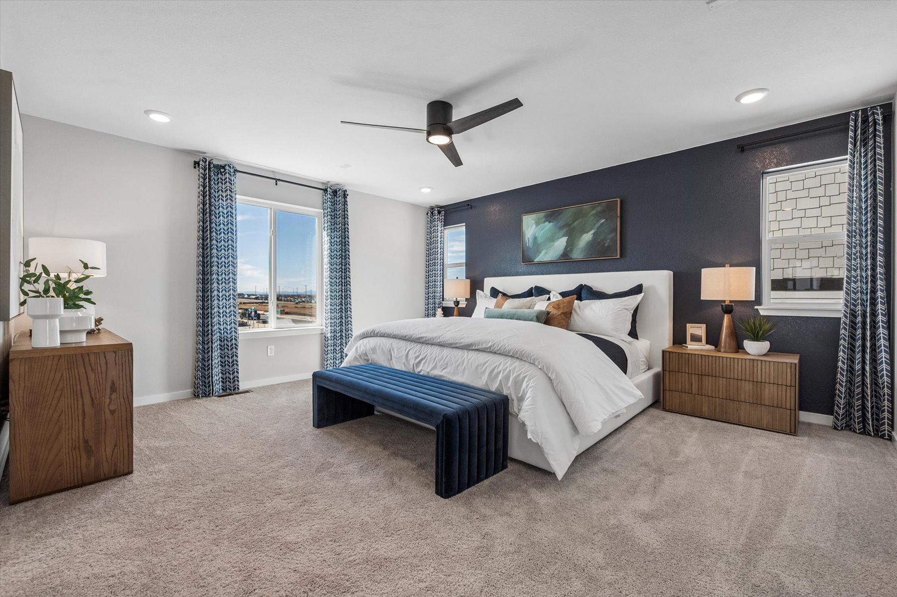 A bedroom with a bed and a bench.