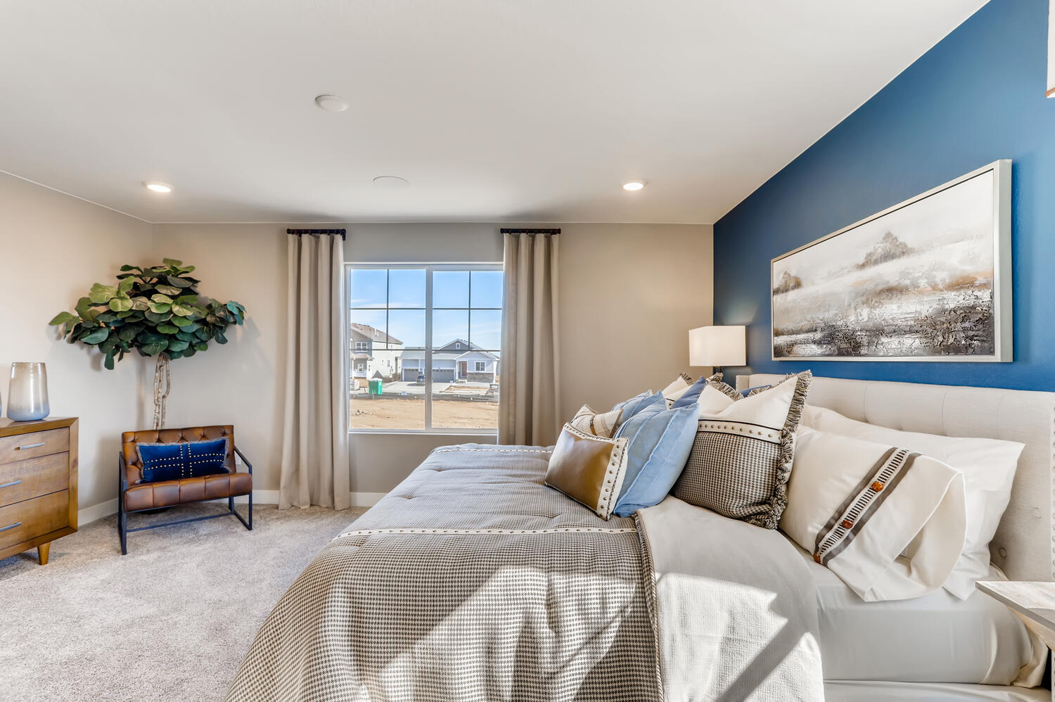 A bedroom with a large window.