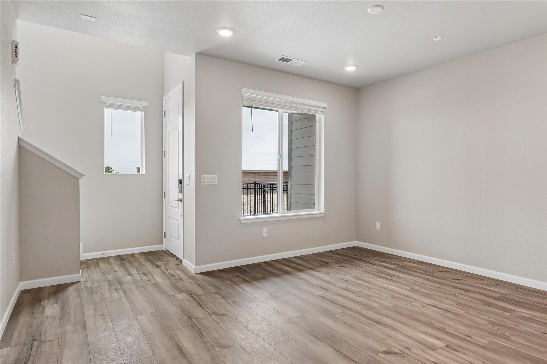 A room with a wood floor and a window.