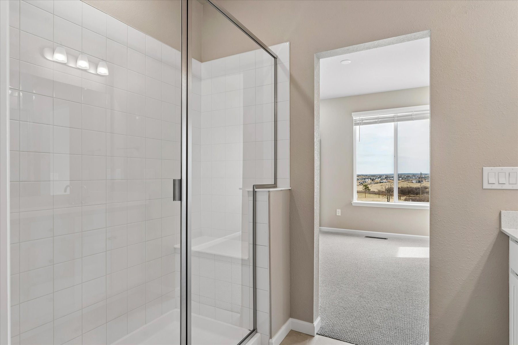 A shower with a glass door.