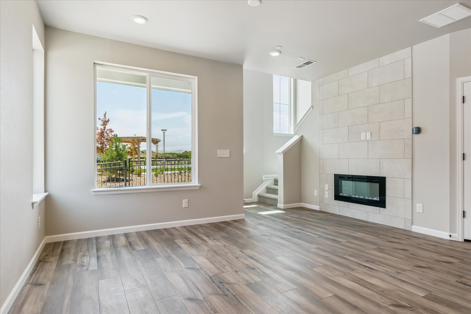 A room with a fireplace and a wood floor.