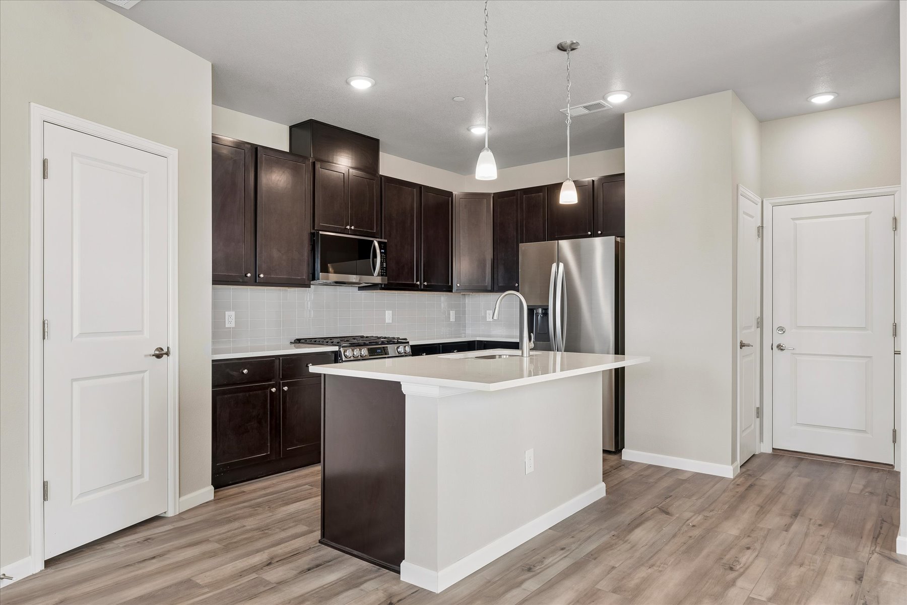 A kitchen with black cabinets.