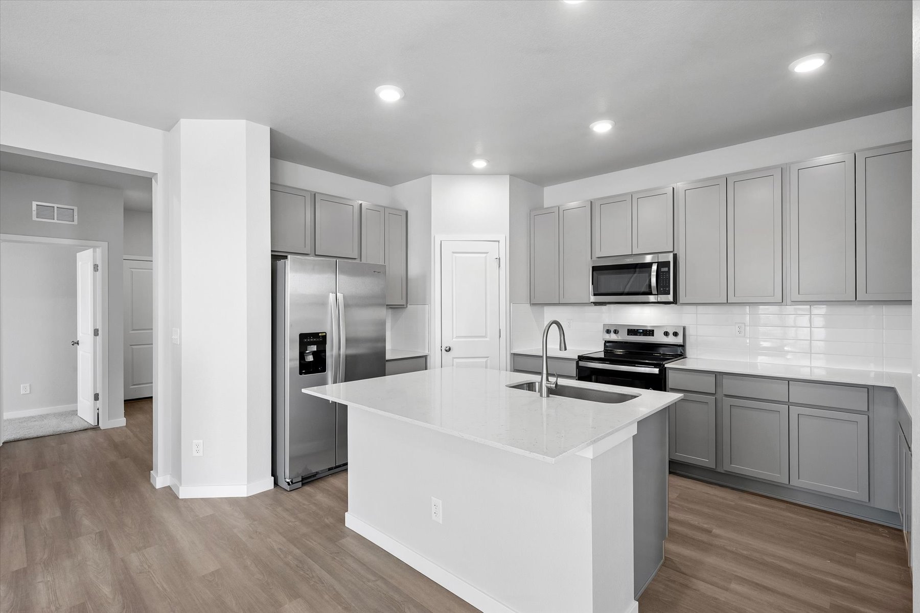 A kitchen with white cabinets.