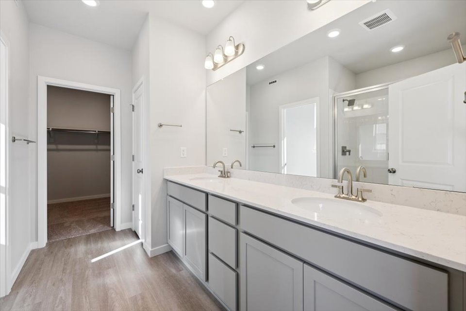 A bathroom with a large mirror.