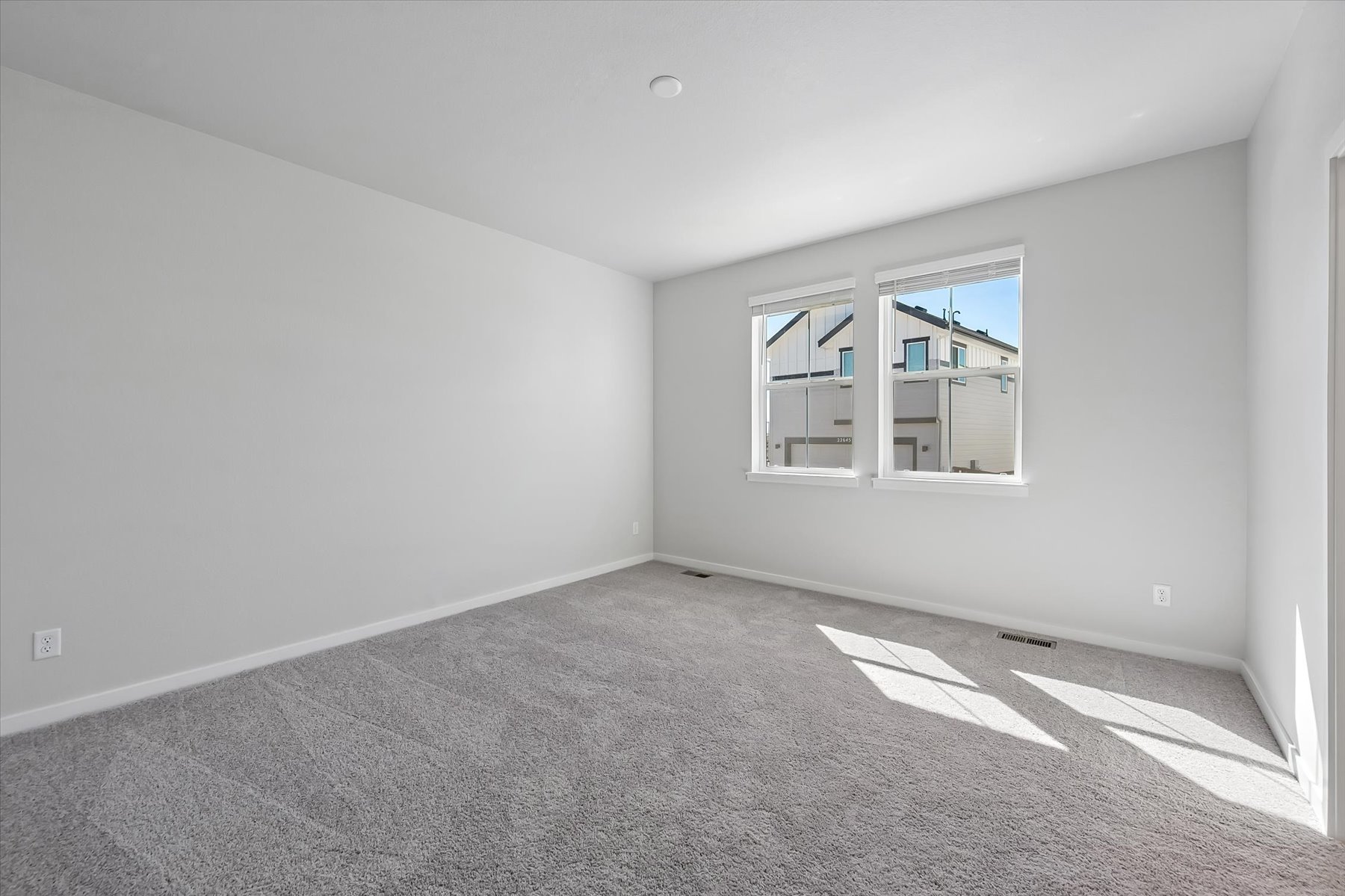 A room with a window and a carpet.