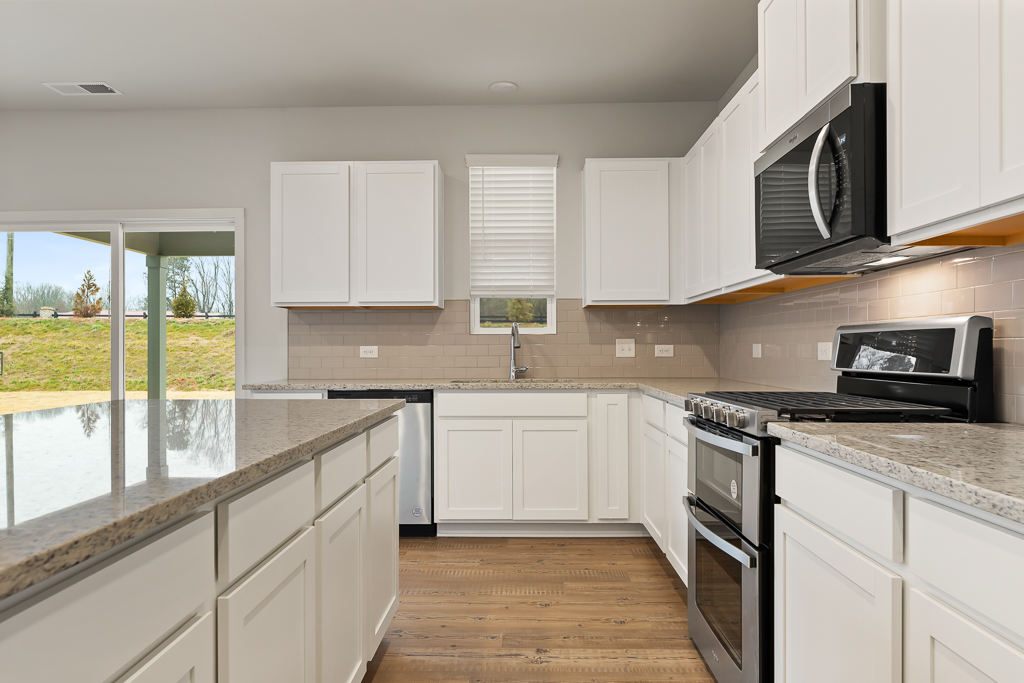 A kitchen with white cabinets.