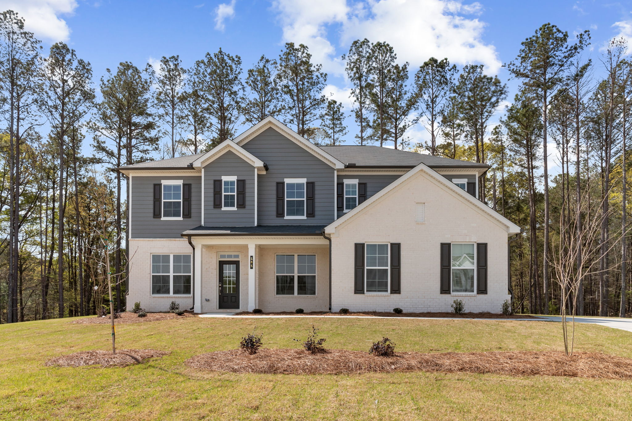 A house with trees in the back.