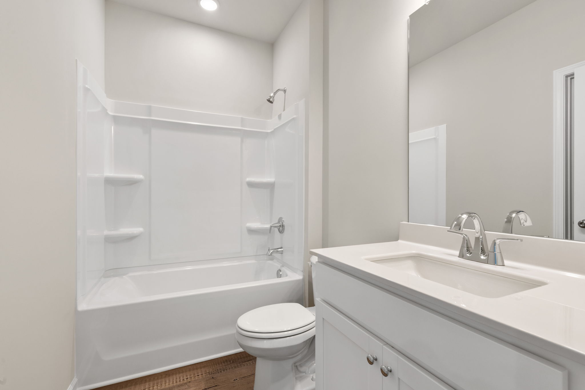 A bathroom with a tub sink and toilet.