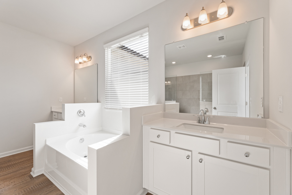 A bathroom with a large mirror.