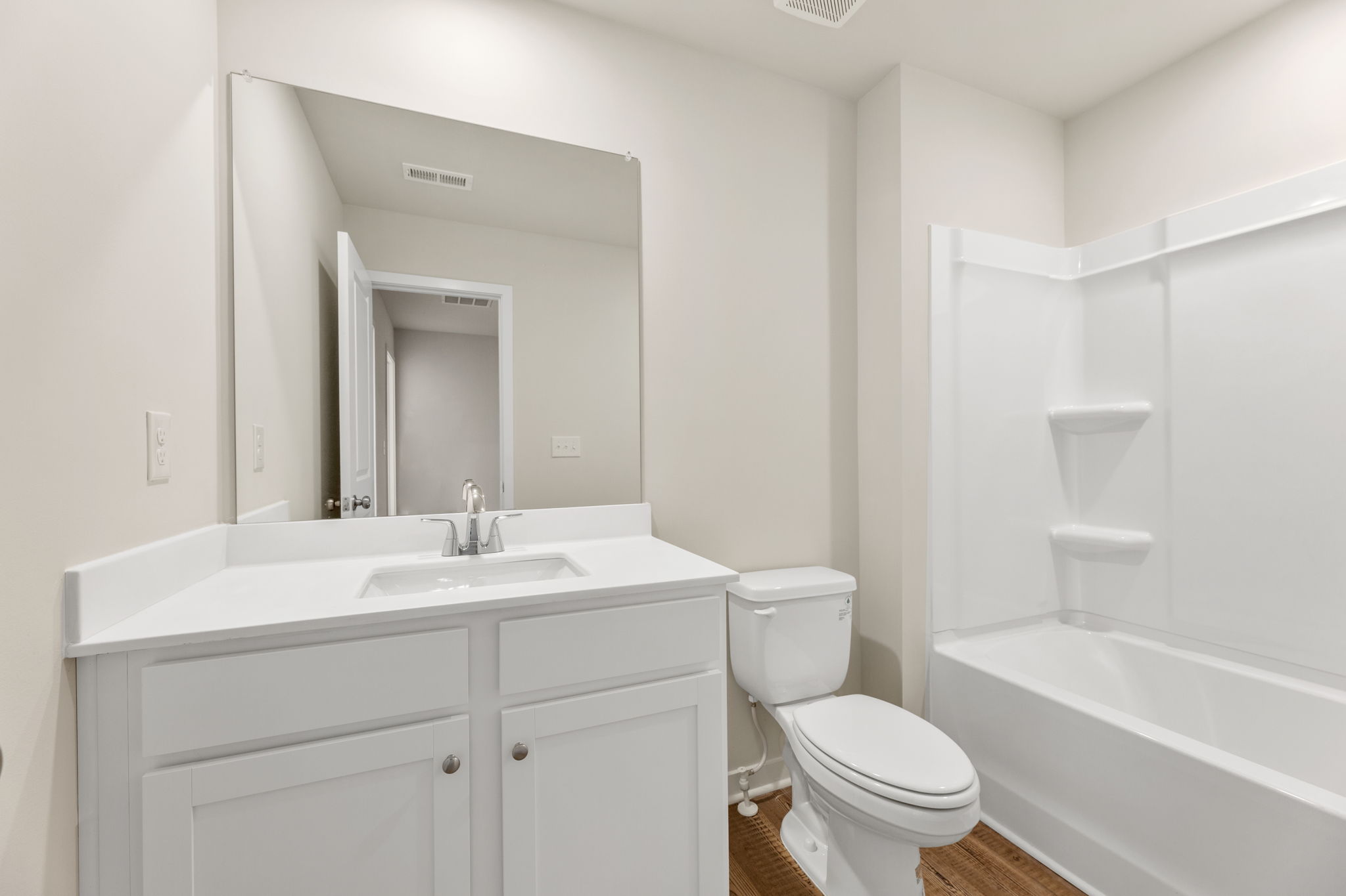 A bathroom with a tub sink and toilet.