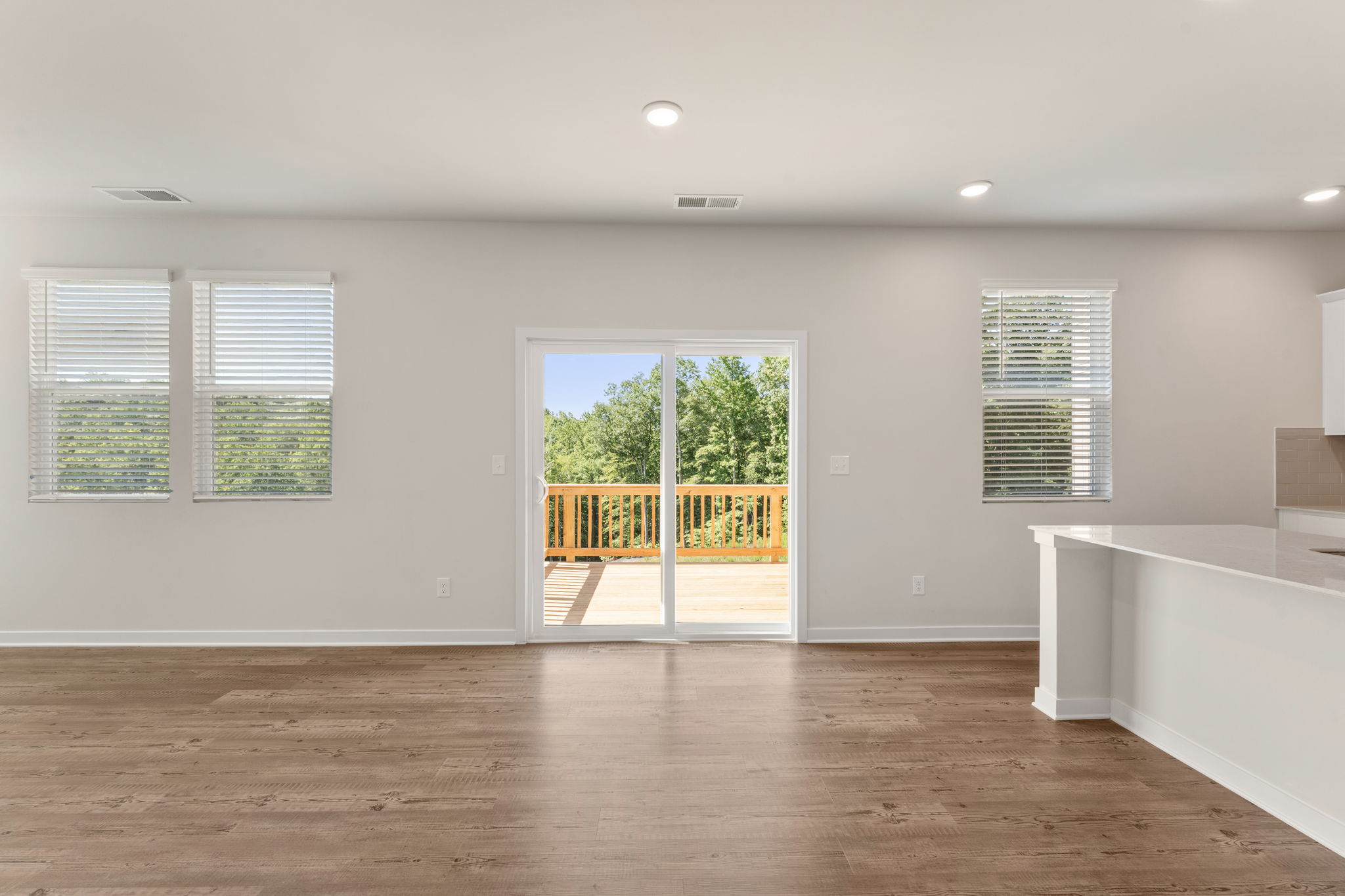 A room with a wood floor and windows.