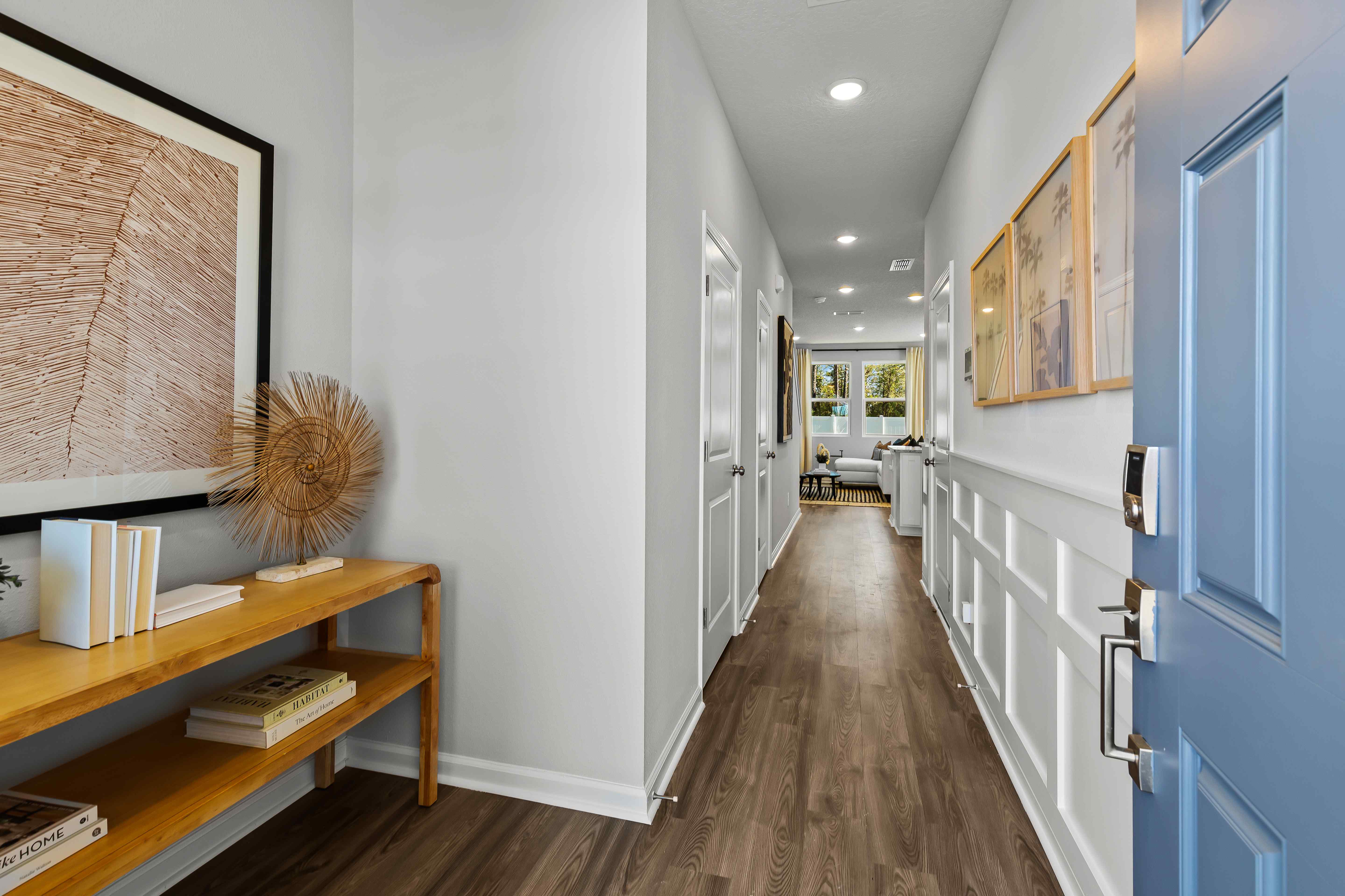 Davor Model Paired Home Entry Foyer with Table and Blue Door at The Landings at Pecan Park