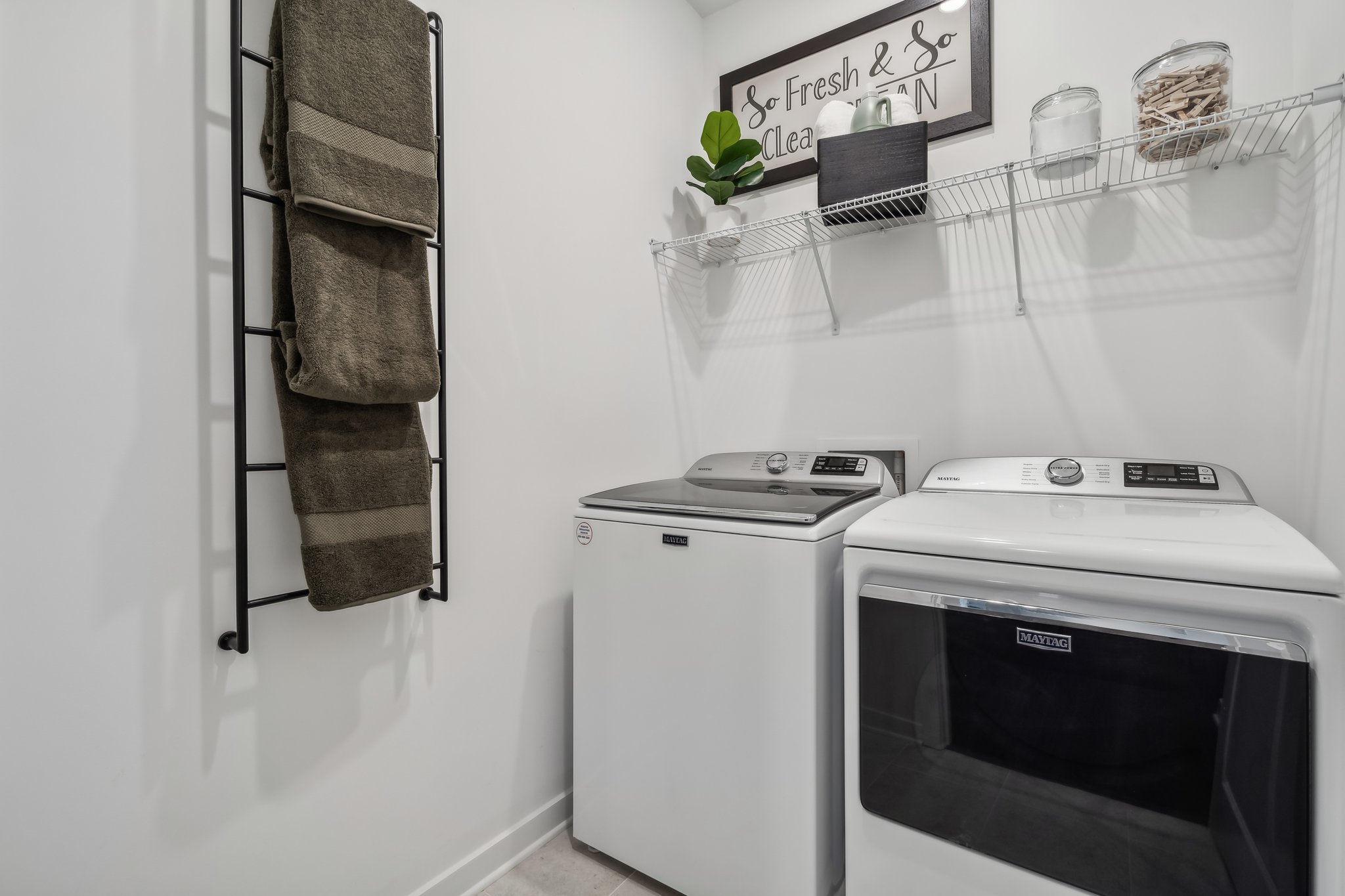 A kitchen with a washer and dryer.