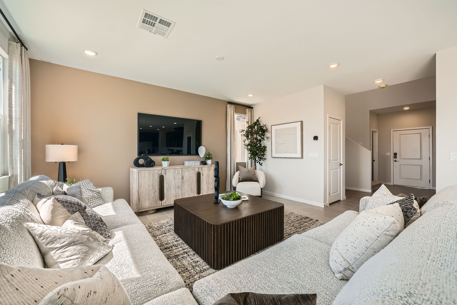 A large living room with a large couch and a table.