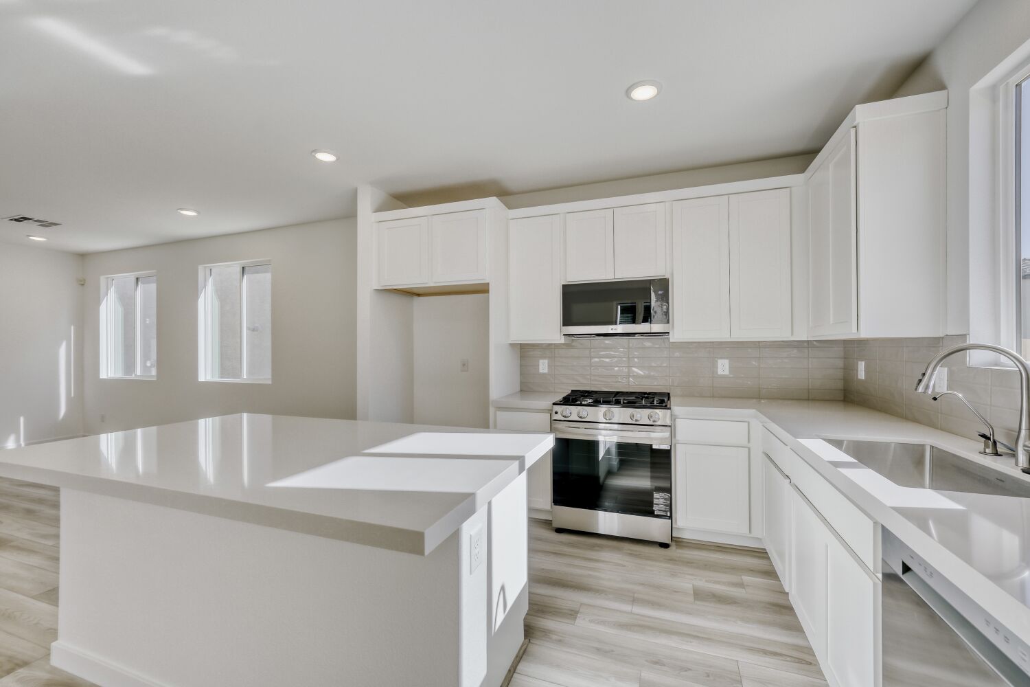 A kitchen with white cabinets.